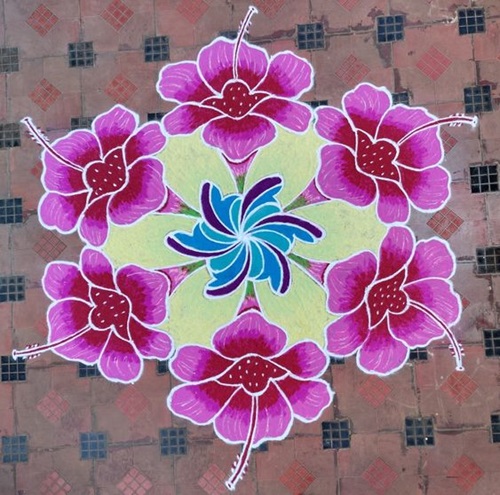 Simple rangoli design of flower on porch floor