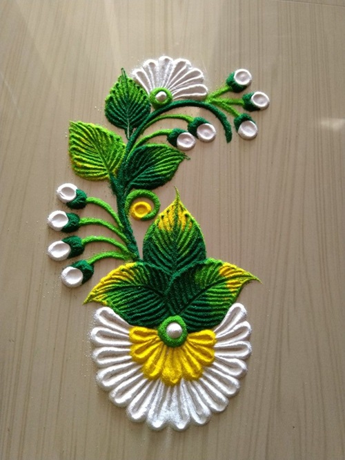 simple rangoli designs of white flowers with green leaves